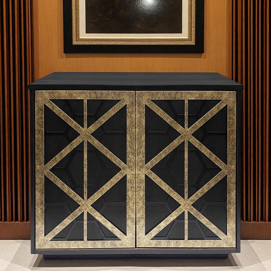 Black cabinet with gold geometric patterns on a wooden floor and wall.