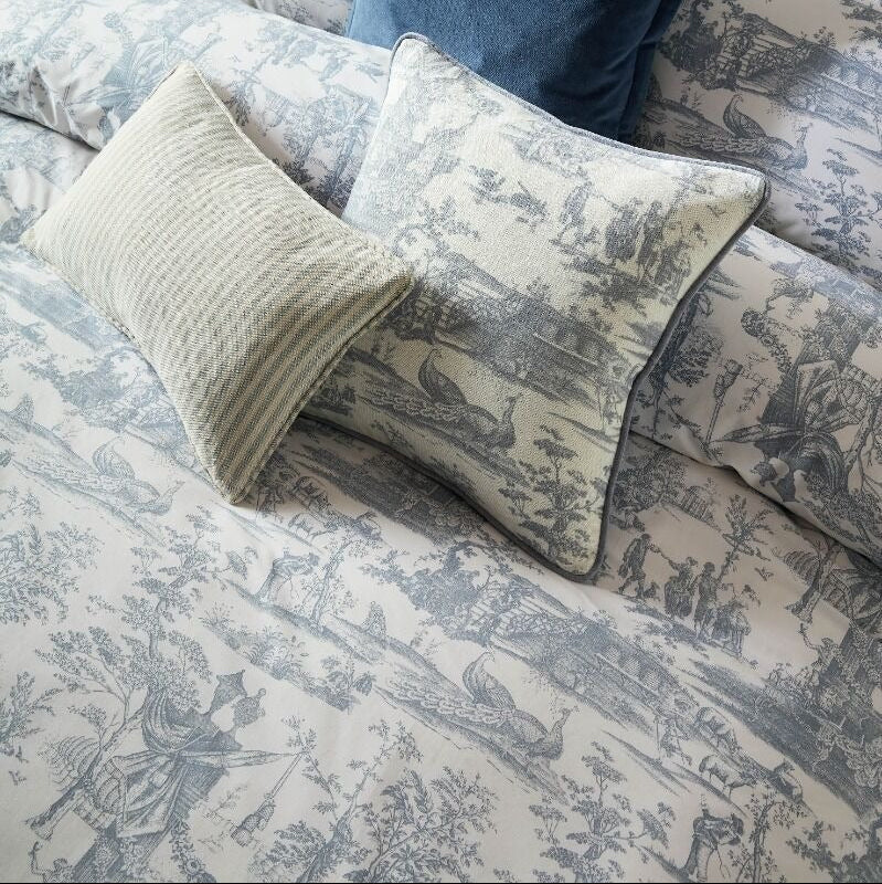 Patterned bedding with decorative pillows on a bed