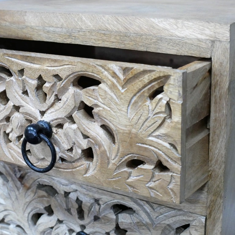 Compact bedside cabinet measuring 48cm in height, 36cm in width, and 37cm in depth, crafted from solid mango wood. Features two drawers with intricately hand-carved floral and geometric patterns on the fronts, finished in a natural wood tone. The cabinet's rustic design and rustic charm make it suitable for various interior styles, including bohemian, farmhouse, and eclectic decors.