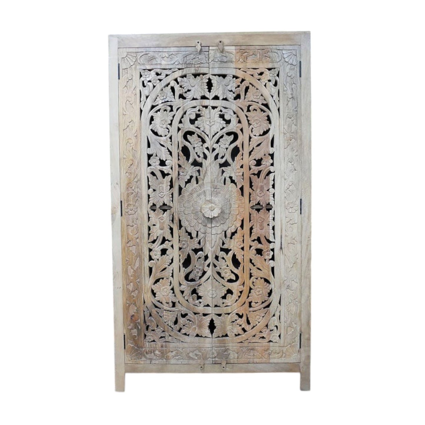 A tall, hand-carved solid mango wood cabinet measuring 180cm in height, 100cm in width, and 40cm in depth. The cabinet features two full-length doors adorned with intricate floral and geometric carvings, reflecting Eastern design influences. Finished in a natural wood tone, this piece offers ample internal storage with shelved compartments, making it both functional and decorative. Suitable for various interior styles, including bohemian, rustic, and eclectic homes.