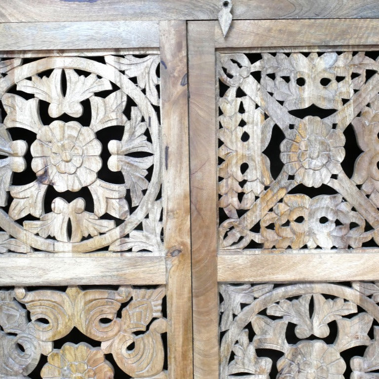 A tall, hand-carved solid mango wood cabinet measuring 180cm in height, 99cm in width, and 41cm in depth. The cabinet features two full-length doors adorned with intricate floral and geometric carvings, reflecting Eastern design influences. Finished in a natural wood tone, this piece offers ample internal storage with shelved compartments, making it both functional and decorative.
Suitable for various interior styles, including bohemian, rustic, and eclectic decors.