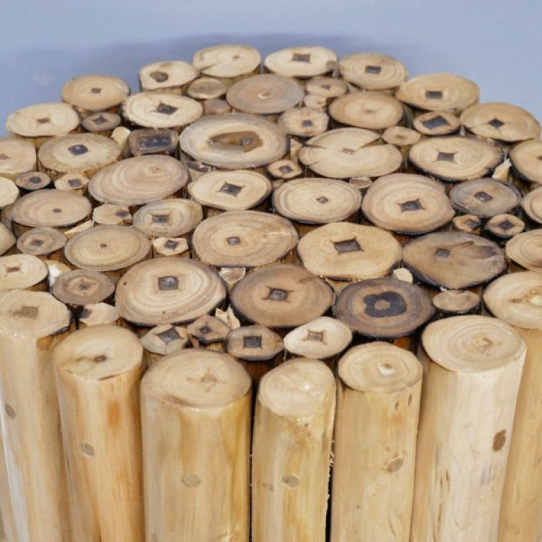 Crafted from natural teak wood, this Coastal Teak Side Table boldly celebrates natural beauty with its unique assembly of wooden tubes. Its raw, untouched finish brings an authentic rustic charm to any living space, and it can even double up as a stool. Perfect for those who dare to embrace a beach house vibe, this piece adds character and warmth.