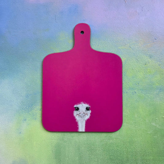 Pink cutting board with an ostrich design on a colorful background