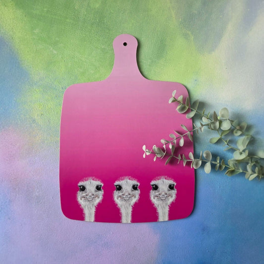 Pink cutting board with ostrich illustrations on a colorful background