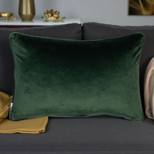 Green pillow on a gray sofa with decorative items in the background