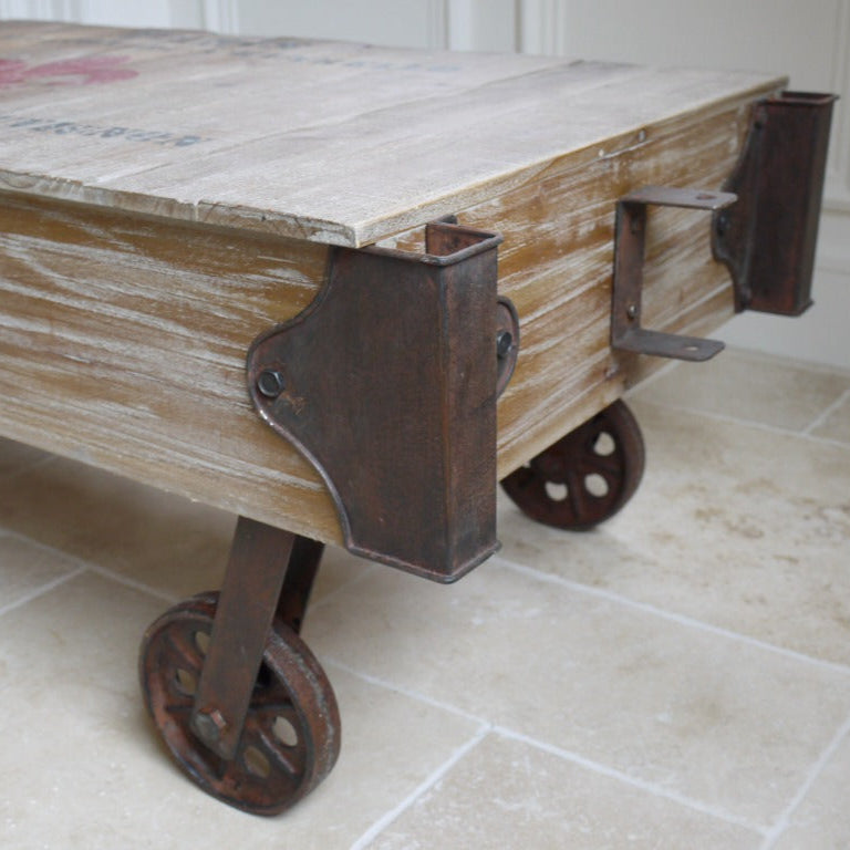 This bold French Railway Style Coffee Table commands attention with its charming, rustic presence. Made of reclaimed wood and adorned with vintage wine crate lettering, it blends tradition with a fun flair. Iron accents and four sturdy wheels enhance its rustic industrial charm, making it a striking centrepiece that transforms any living room into a stylish statement space!