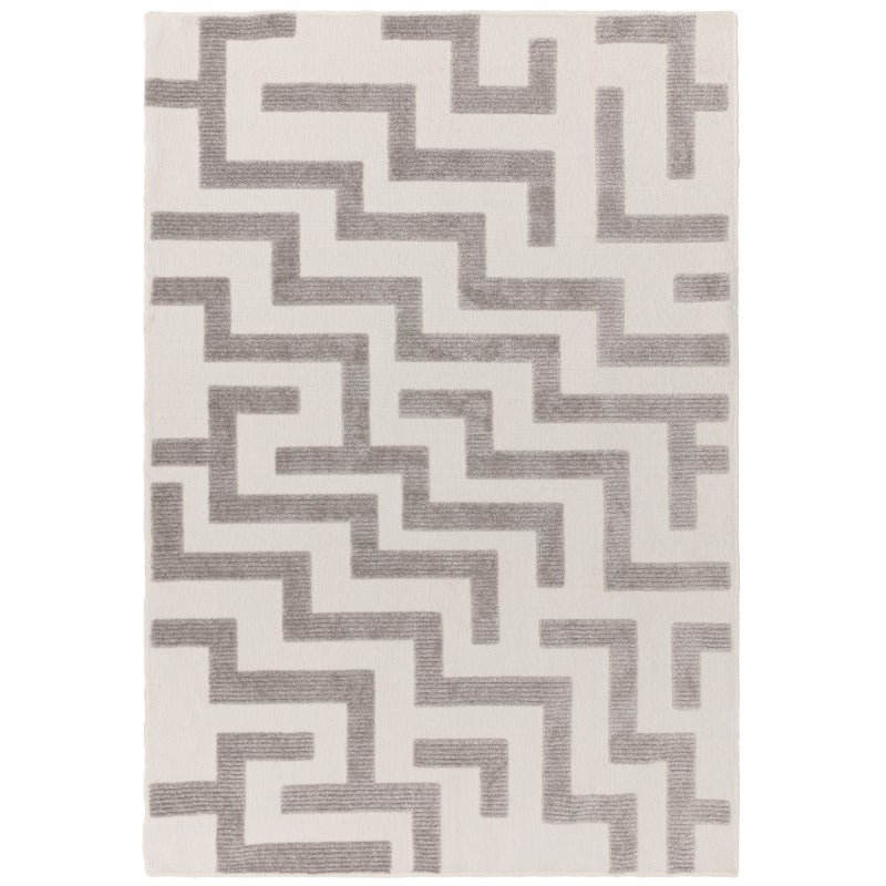 A grey geometric patterned rug with a low pile technique.
