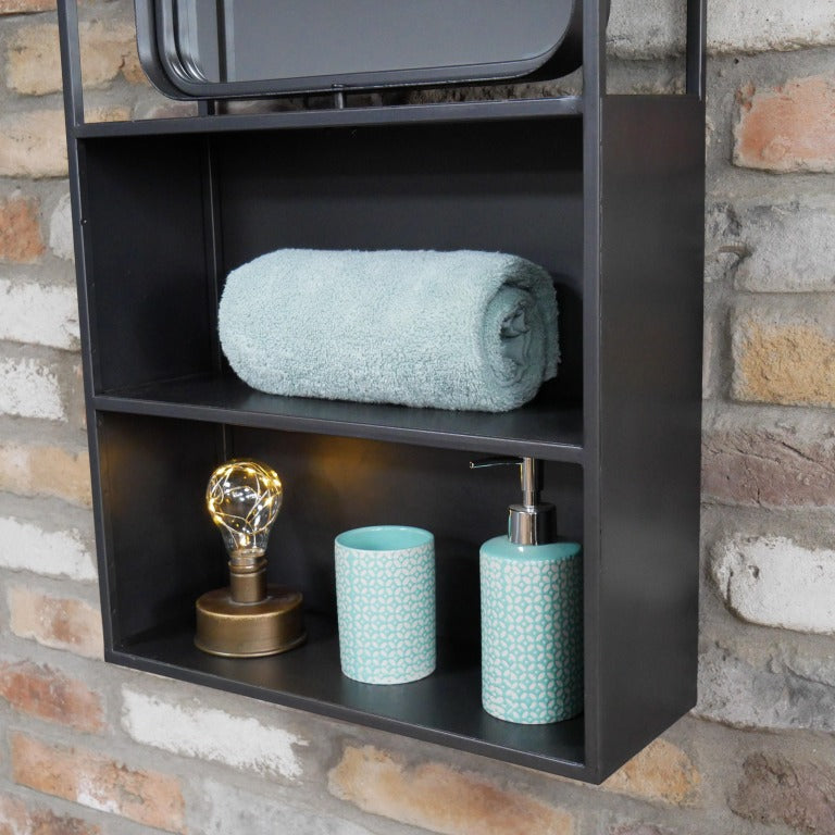Keep your home stylishly organised with our Industrial Black Wall Mirrored Unit! This large rectangular shelf boasts a sleek black metal finish that screams industrial chic. Two spacious shelves are just begging to showcase your favourite things, and the built-in mirror at the top also adds that perfect rustic flair. With easy-to-use hooks for mounting, this playful piece will jazz up any bathroom, hallway, or kitchen!
