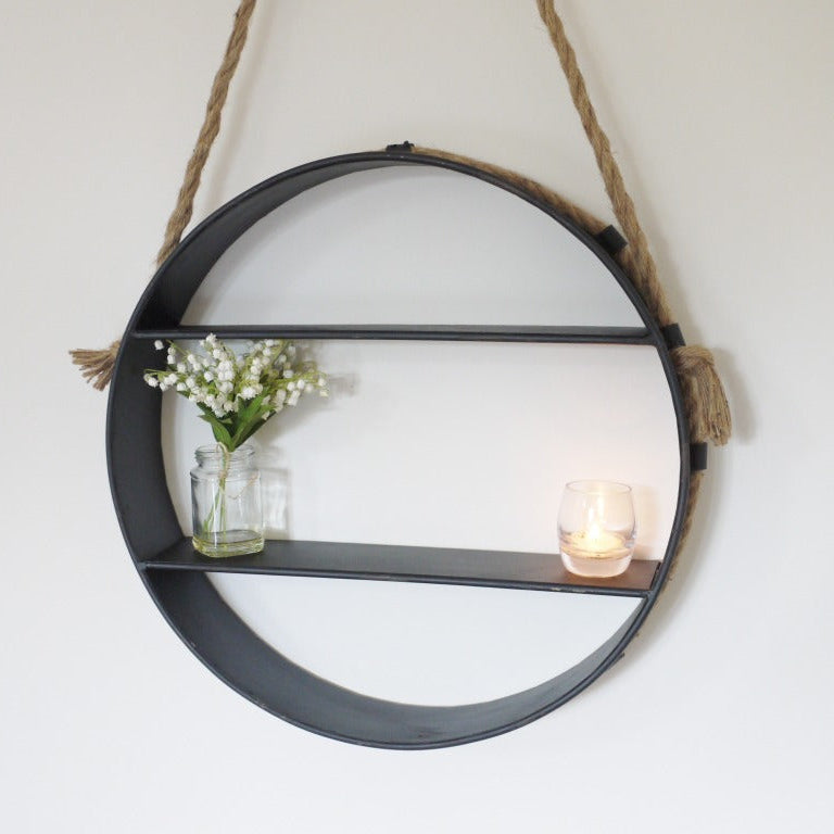 This Industrial Round Rope Hanging Shelf combines rustic charm with industrial style, making it perfect for any interior wall. It features two spacious shelves for easy display and a stylishly rustic rope loop for simple hanging. Finished with an antique effect, it adds a touch of vintage character while providing practical storage. A stylish and functional addition to your home that supports organised and attractive living spaces!