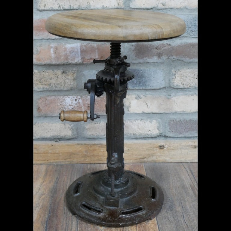 Adjustable-height industrial stool with a round mango wood seat and black iron base, measuring 30cm in diameter. The seat height ranges from 46cm to 60cm, allowing for versatile use. The stool's minimalist design and combination of natural wood and metal materials make it suitable for various interior styles, including industrial, rustic, and contemporary decors.