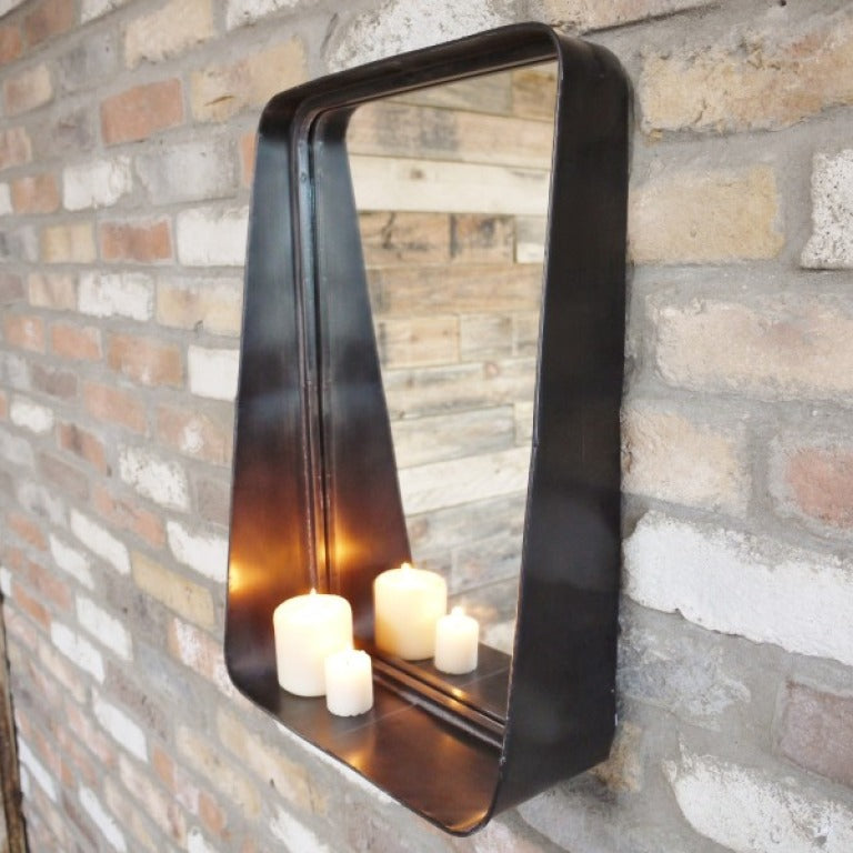 This Industrial Metal Wall Mirror combines style and practicality, perfect for industrial and rustic interiors. Crafted from metal with a dark finish, it adds a sophisticated touch to any room. The small shelf at the bottom offers convenient storage. Its sleek design ensures it complements a variety of decor styles, making it a versatile and functional addition to your home.