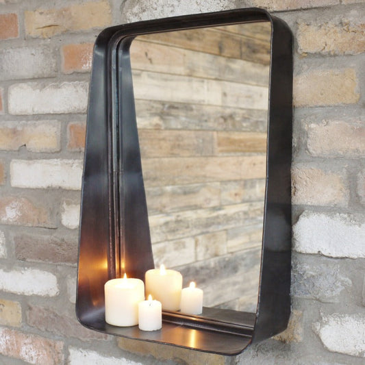 This Industrial Metal Wall Mirror combines style and practicality, perfect for industrial and rustic interiors. Crafted from metal with a dark finish, it adds a sophisticated touch to any room. The small shelf at the bottom offers convenient storage. Its sleek design ensures it complements a variety of decor styles, making it a versatile and functional addition to your home.