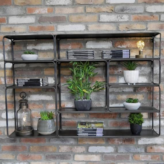 This Industrial Metal Wall Shelf Unit features asymmetrical shelves of varying sizes, creating a unique and stylish storage solution. The durable metal construction adds an authentic industrial touch to your space. Perfect for displaying treasured items while complementing rustic or modern decor themes in any room of your home!