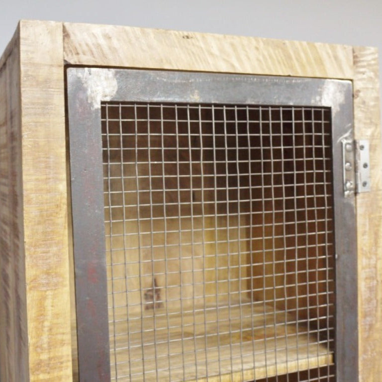This Industrial Wood and Metal Cabinet combines rustic mango wood with durable metal for a stylish, practical storage solution. Featuring four compartments visible through a metal mesh door secured by a unique chain lock, it offers both elegance and security. Its industrial-worn metal fittings and sturdy wooden legs ensure stability, making it ideal for living rooms, hallways, or bedrooms.
