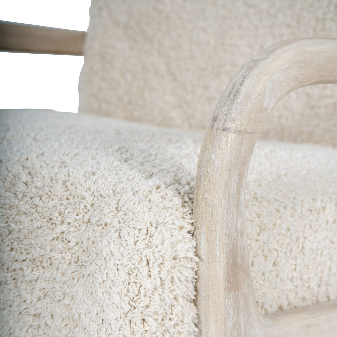 Close-up of a textured white chair with a blurred background