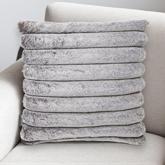 gray plush cushion on a white couch