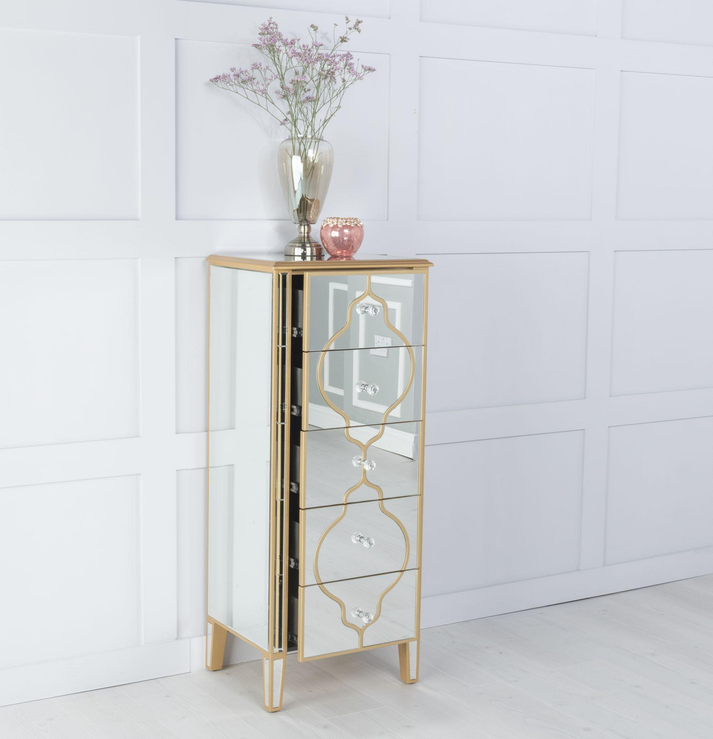 Tall mirrored cabinet with gold accents on a white floor and wall.