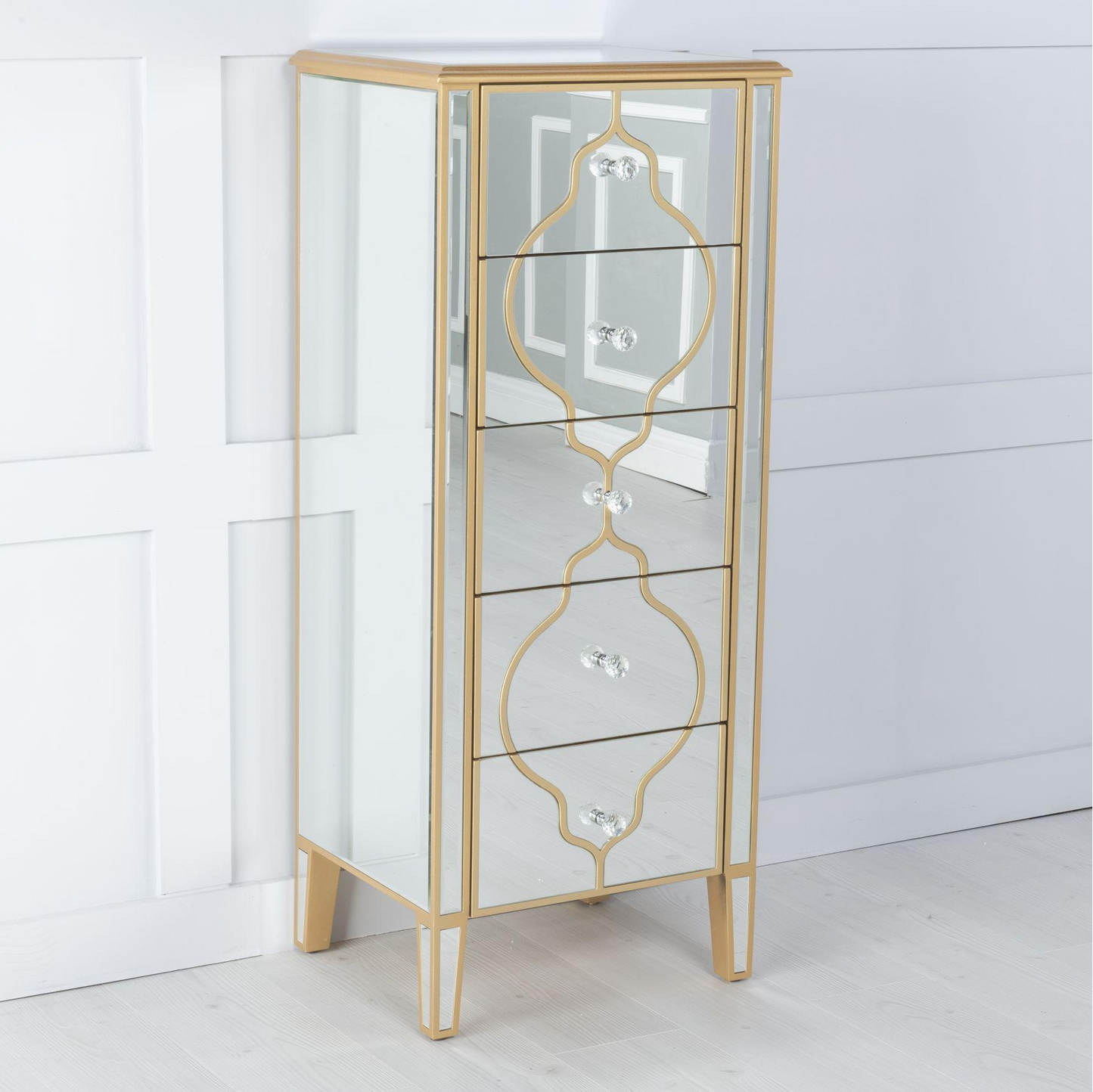 Tall, narrow cabinet with gold mirror accents on a white background