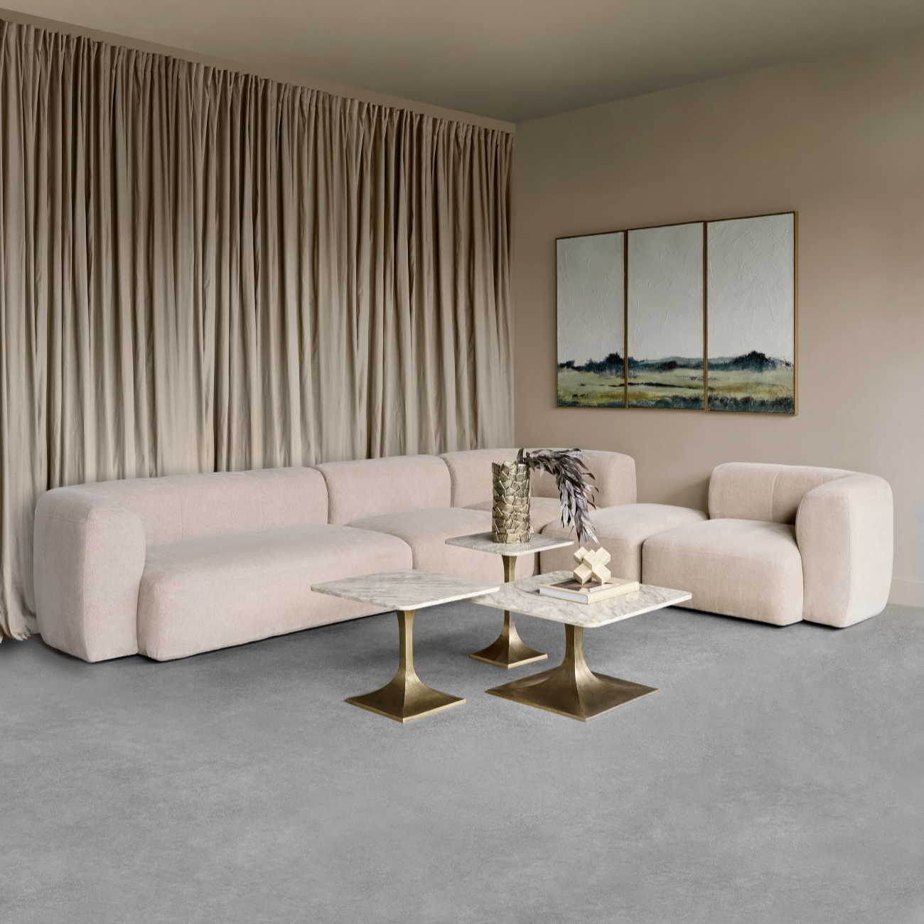 Modern living room with a beige sofa, marble coffee table, and abstract artwork.