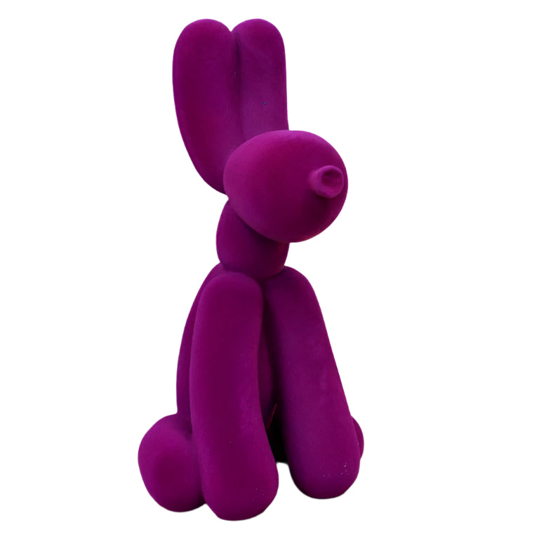 Add bold personality into your space with this Purple Velvet Resin Balloon Dog. Featuring a sleek velvet-effect finish, this charming ornament adds a playful, stylish touch to any room, inspired by the infamous Jeff Koons dogs. Its vibrant purple colour and unique design make it a standout piece that sparks conversation and elevates your decor with an artsy, daring flair!