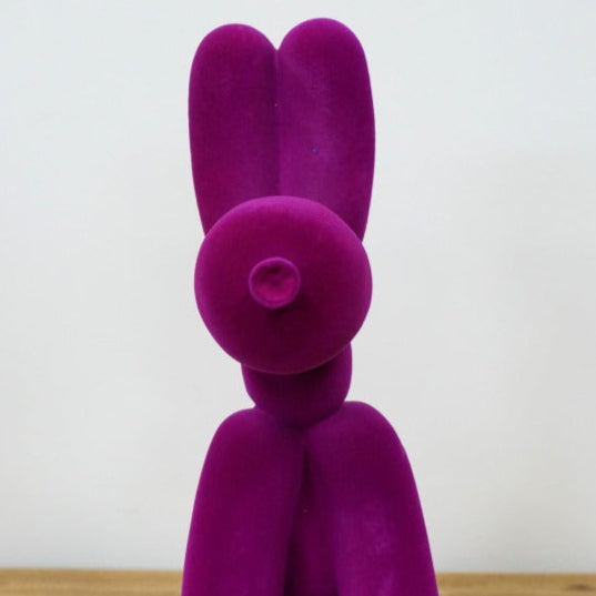 Add bold personality into your space with this Purple Velvet Resin Balloon Dog. Featuring a sleek velvet-effect finish, this charming ornament adds a playful, stylish touch to any room, inspired by the infamous Jeff Koons dogs. Its vibrant purple colour and unique design make it a standout piece that sparks conversation and elevates your decor with an artsy, daring flair!