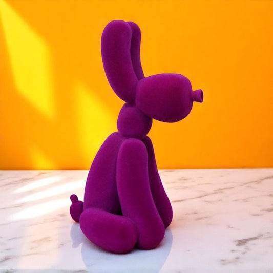 Add bold personality into your space with this Purple Velvet Resin Balloon Dog. Featuring a sleek velvet-effect finish, this charming ornament adds a playful, stylish touch to any room, inspired by the infamous Jeff Koons dogs. Its vibrant purple colour and unique design make it a standout piece that sparks conversation and elevates your decor with an artsy, daring flair!