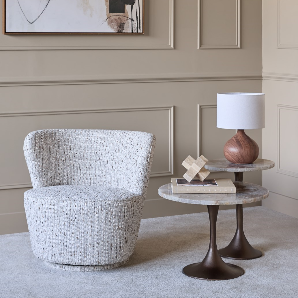 Modern interior with abstract art, chair, and side table.