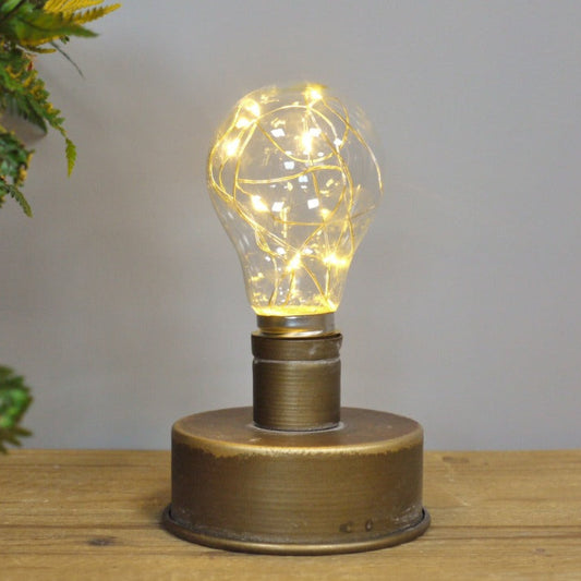 Illuminate your space with the Rustic Brass-Look Bulb Light. Powered by 2 AA batteries, it offers a warm, inviting glow that enhances any room. The industrial-style weathered finish adds a rustic charm, making it a stylish and versatile addition to your decor. Easy to move and place, it helps create a cosy, welcoming atmosphere wherever you choose!