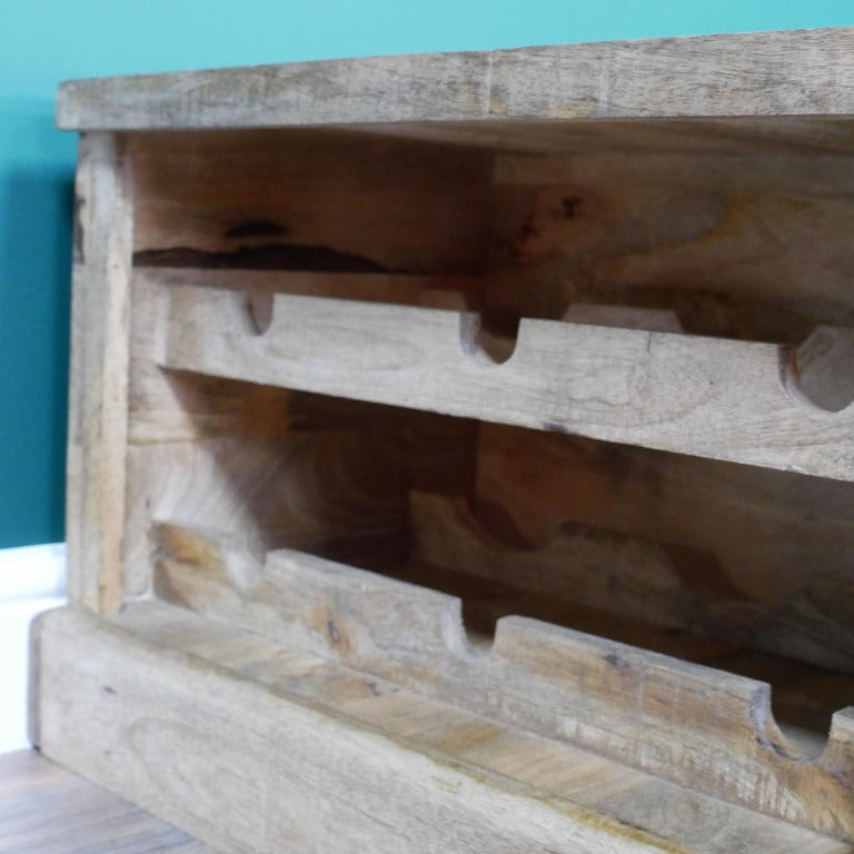 Embrace rustic style with this Rustic Wood Wine Trunk, which provides both a surface to place your favourite items on, and storage for your favourite bottles. Its rugged charm is amplified by an integrated wine rack in a crate design, perfect for showcasing your favourite bottles with flair. The spacious trunk compartment offers ample hidden storage, keeping your space effortlessly organised! Ideal for rustic, boho and coastal spaces.