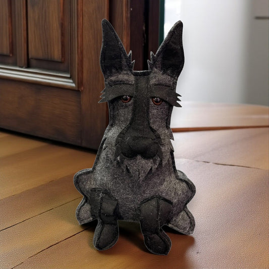 Felt dog door stop sitting on a wooden floor