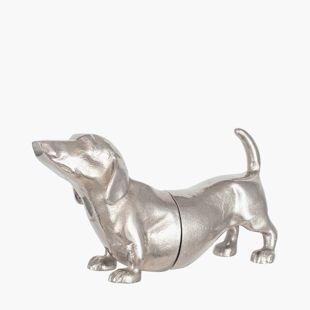 A pair of bookends, in silver metal, in the shape of a sausage dachshund dog. The books slot into the middle. A perfect gift for dog lovers and bookworms!