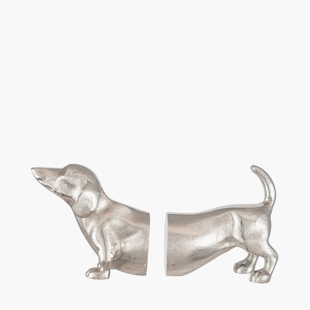 A pair of bookends, in silver metal, in the shape of a sausage dachshund dog. The books slot into the middle. A perfect gift for dog lovers and bookworms!