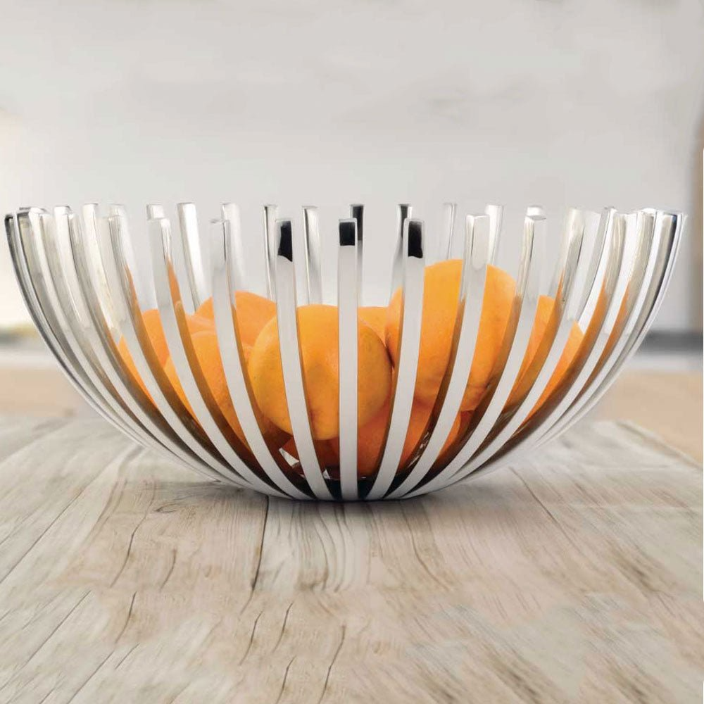 Silver wire fruit bowl with oranges on a wooden surface