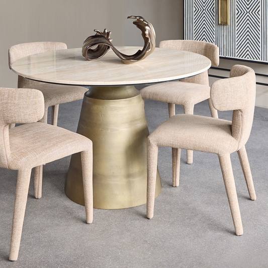 Dining table with marble top and gold base in a modern room.