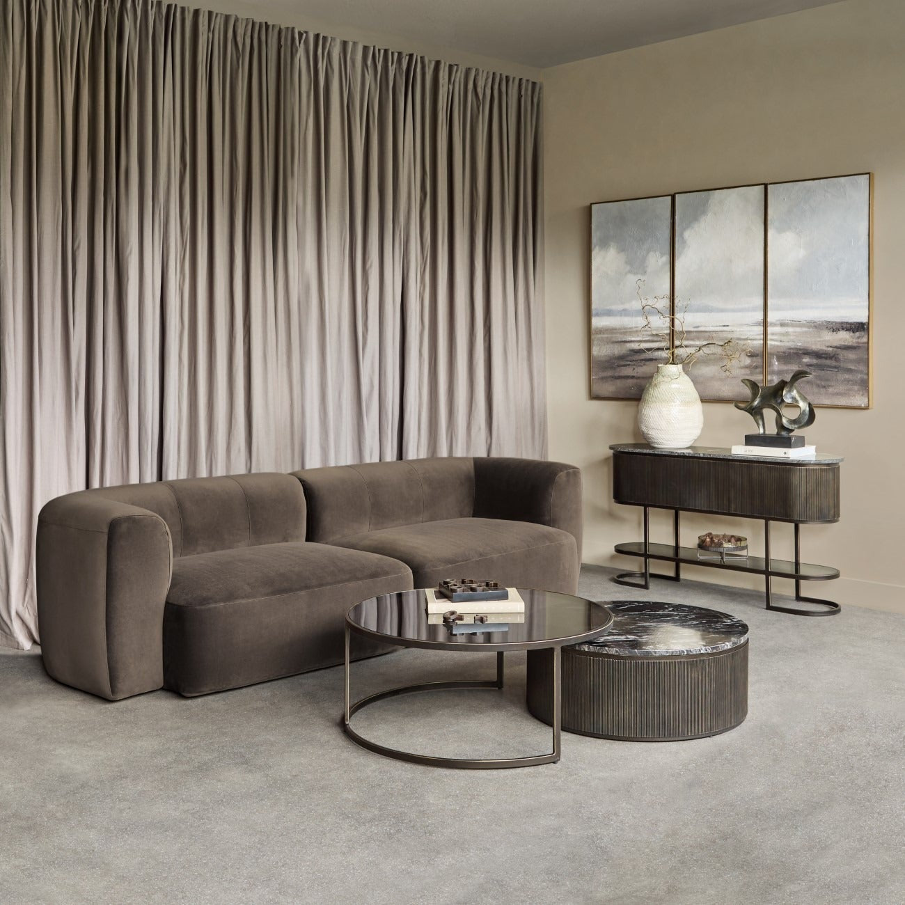 Modern living room with a brown sofa, coffee table, and decorative items.