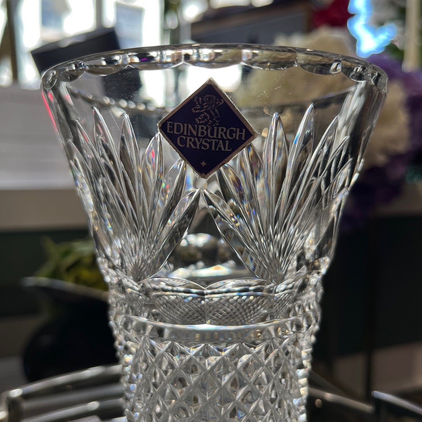 Crystal glass with Edinburgh Crystal logo on a blurred background