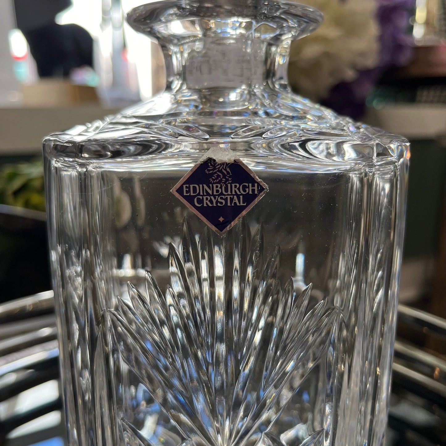 Edinburgh Crystal glass decanter with intricate design and visible brand logo.