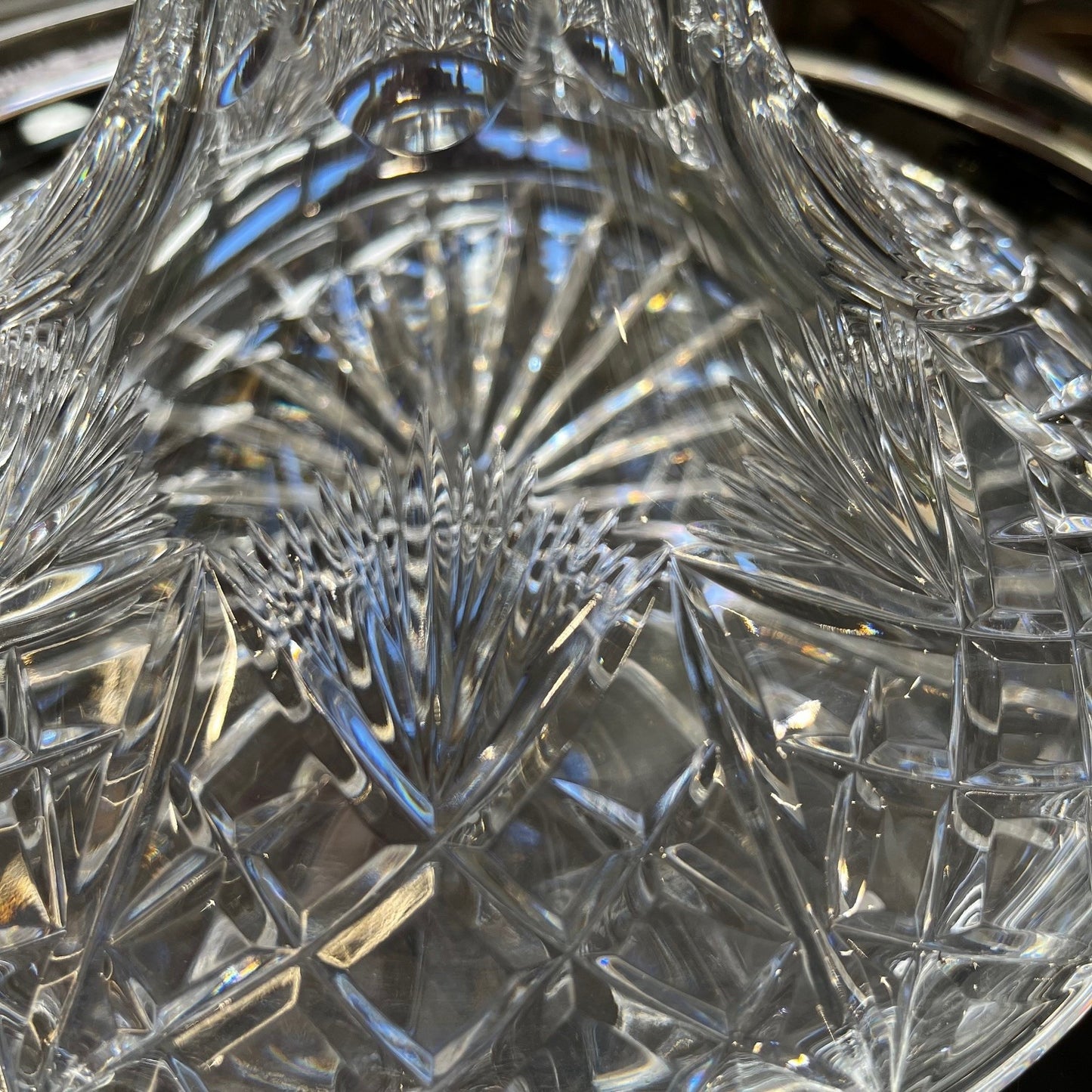 Close-up of a crystal decanter with intricate cut patterns