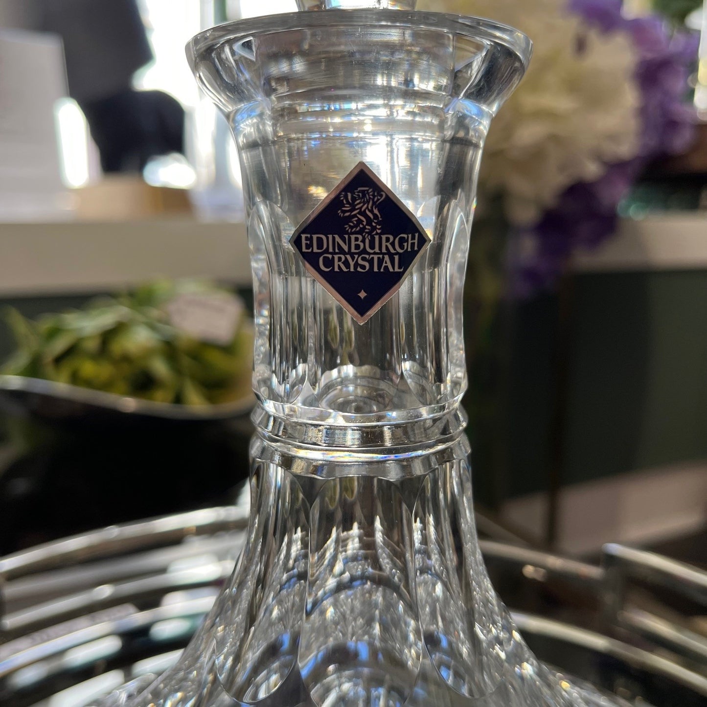 Clear crystal vase with Edinburgh Crystal logo on a blurred background