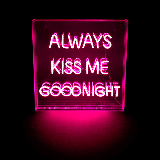 Neon sign with the text 'Always Kiss Me Goodnight' on a black background