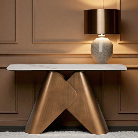 Bronze console table with a lamp against a brown paneled wall
