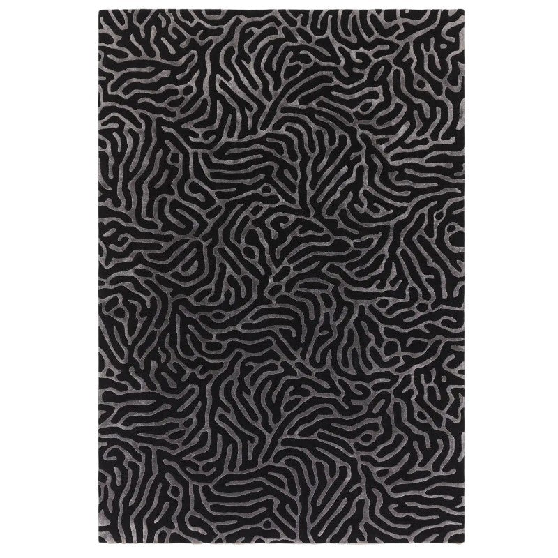 Black and gray abstract patterned rug on a white background