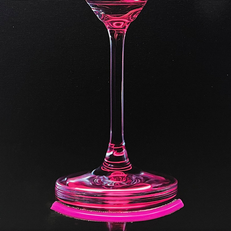 Neon pink cocktail in a glass with a lemon slice on a black background