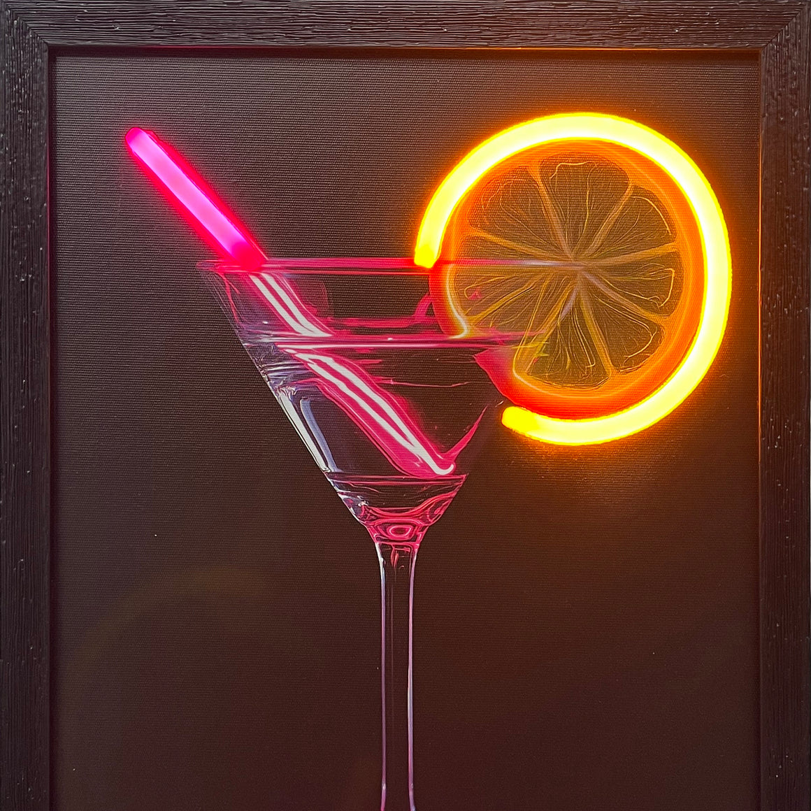 Neon sign of a cocktail glass with a lemon slice and pink straw on a dark background