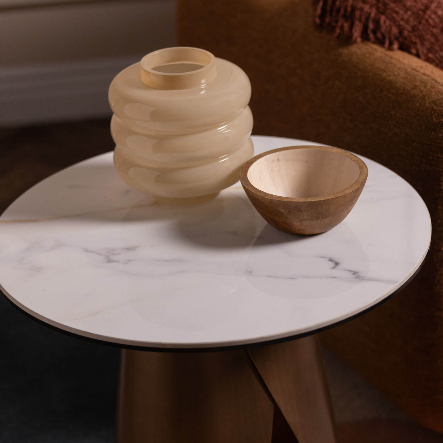 Two ceramic vases on a marble table with a blurred background