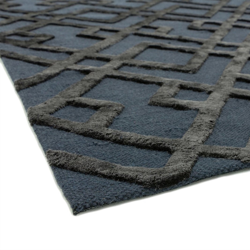 Close-up of a textured black rug with geometric pattern