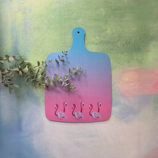 Gradient cutting board with flamingo design on a colorful background