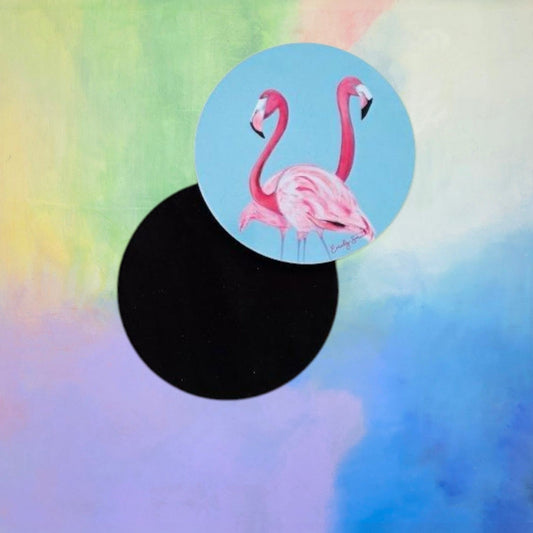 Two pink flamingos on a blue circle against a colorful, abstract background