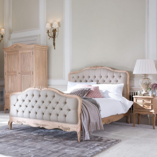 Neatly arranged bedroom with a bed, wardrobe, and side tables.