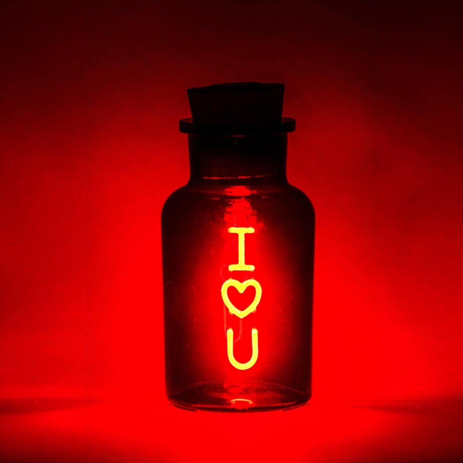 Glass bottle with 'I heart U' text on a red background